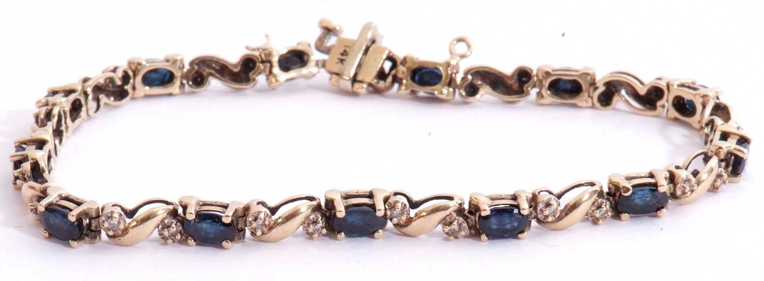 Sapphire and diamond line bracelet, alternate set with 13 oval shaped dark sapphires and 26 small - Image 2 of 5