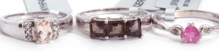 Mixed Lot: morganite and white topaz ring, a smoky quartz three stone ring, together with a pink