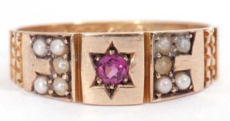 Antique 9ct gold ruby and seed pearl ring centring a round cut ruby in a star engraved setting,