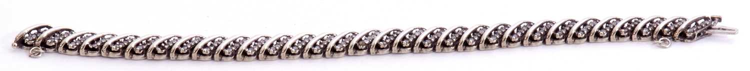 Precious metal diamond set articulated bracelet, the design featuring rows of five small single - Image 3 of 4
