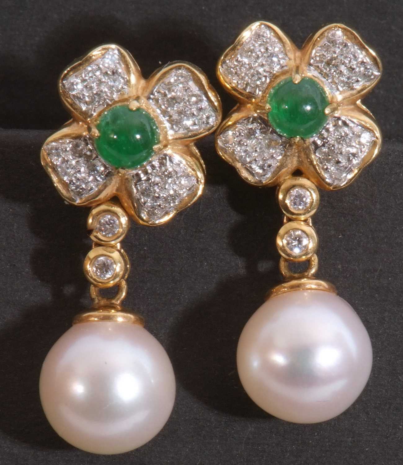 Pair of diamond, emerald and cultured pearl drop earrings, the flowerhead centring a small