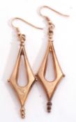 Pair of yellow metal Etruscan style large drop earrings of plain pierced angular design with