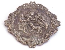 Large white metal Dutch brooch embossed with figures and a dog, all in a pierced scroll frame, 7 x