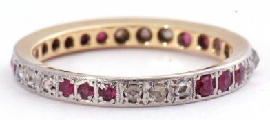 Precious metal ruby and diamond full eternity ring, a design featuring groups of three small old cut