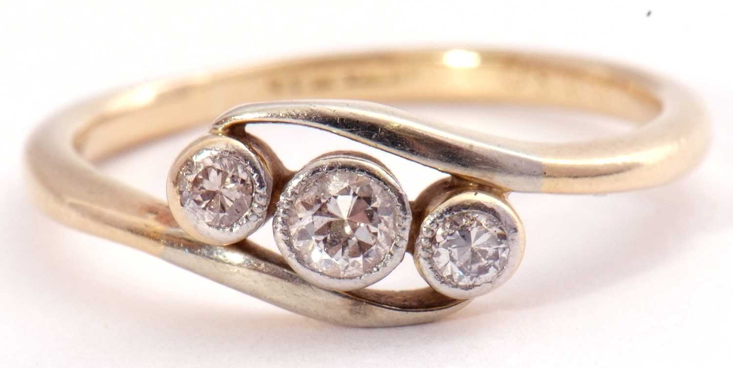 Three stone diamond cross over ring, a row of three graduated old brilliant cut diamonds, each in