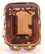 Large cognac citrine dress ring of rectangular shape in a filigree style mount to a plain polished