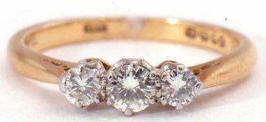 Three stone diamond ring featuring three small graduated round brilliant cut diamonds, 0.25ct