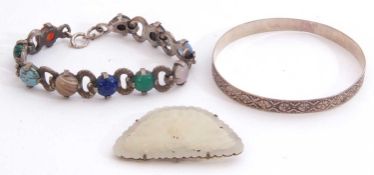 Mixed Lot: celadon jade pierced brooch, a chased and engraved bangle stamped 'silver' together