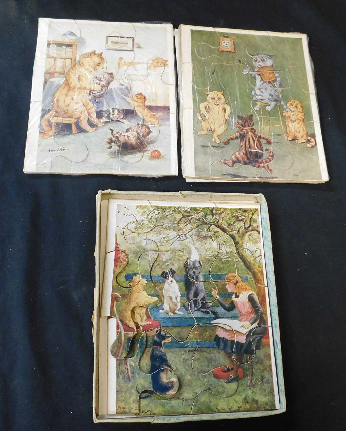 Two vintage Louis Wain jigsaw puzzles on card plus one other, 180 x 140mm, original battered box