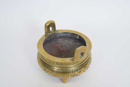 Small Chinese brass censer on three stub feet, 12cm diam