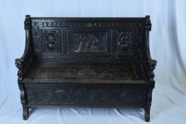 Victorian dark Gothic oak hall seat, profusely carved throughout the back, with figural panels,