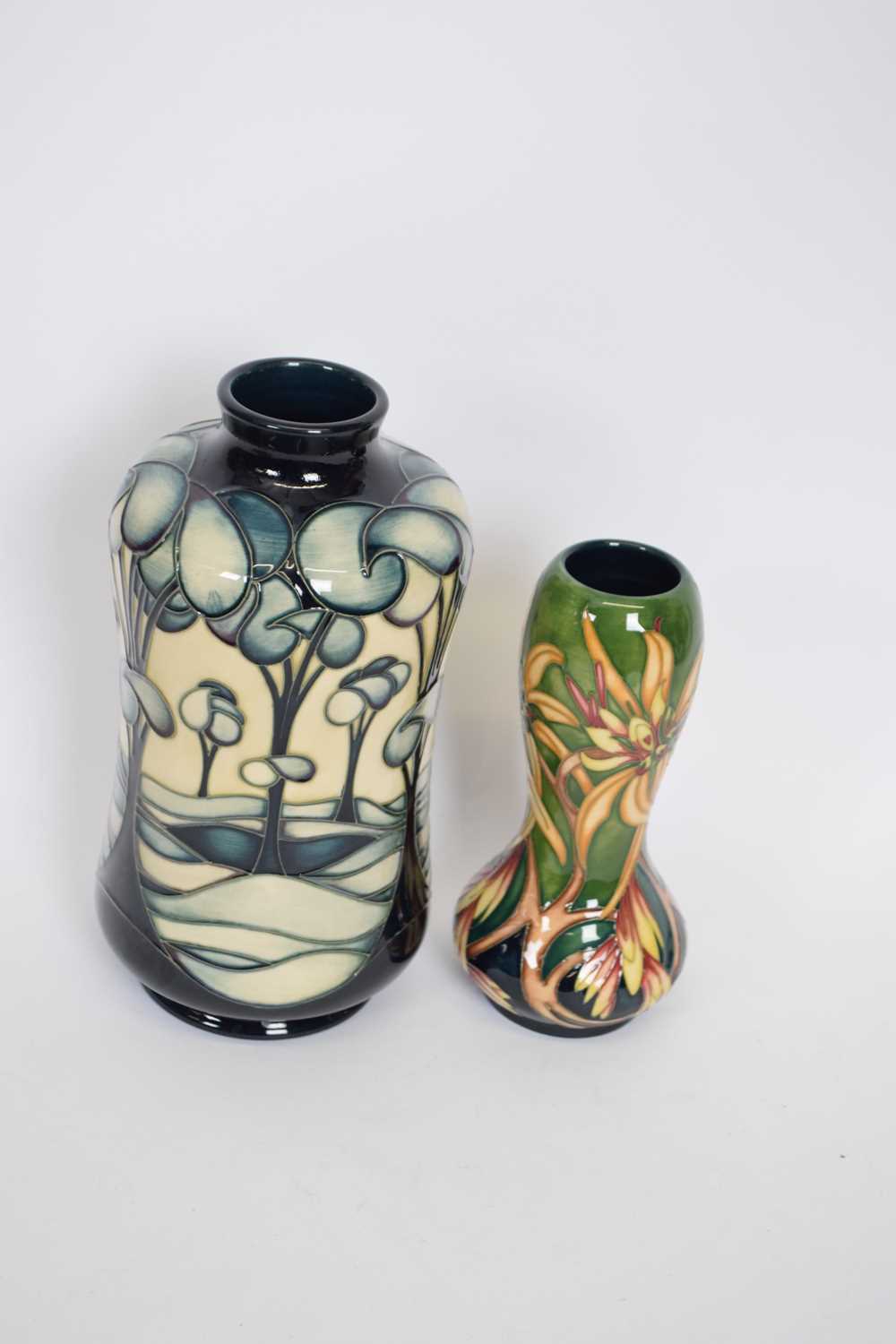 Two Moorcroft trial vases, one with tube lined stylised trees in a landscape, marked 'trial 23805'