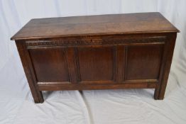 18th century oak coffer with two board hinged lid over a body with three panelled front raised on