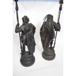 Pair of 19th century bronzed spelter models of lance wielding soldiers, raised on circular plinth