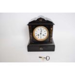 Late 19th century black slate mantel clock, the dial flanked by two columns, complete with key, 26cm