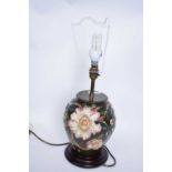 Moorcroft table lamp with tube lined floral design with beige shade