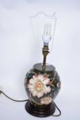 Moorcroft table lamp with tube lined floral design with beige shade