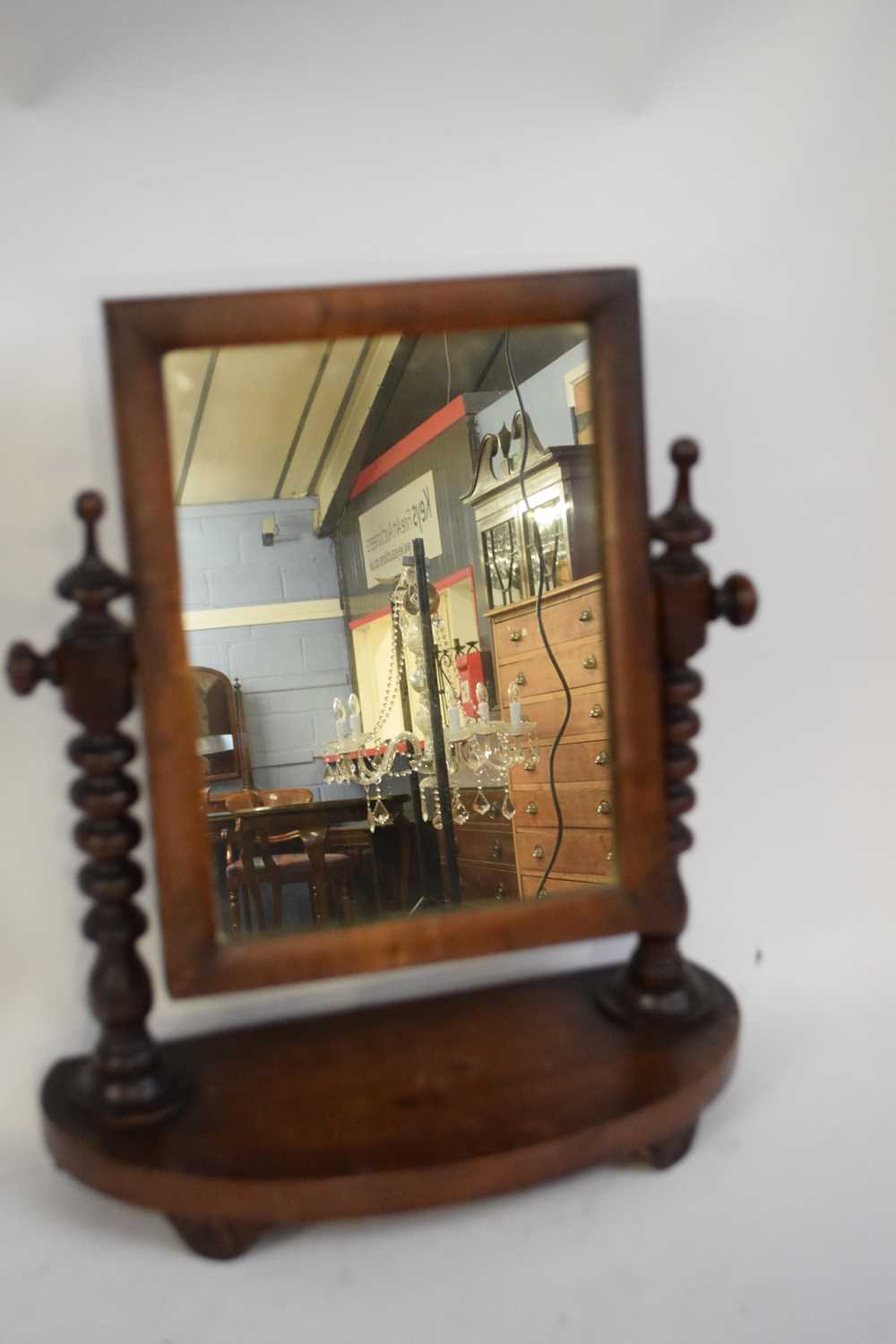 Small Victorian dressing table mirror, mahogany frame, turned side supports and a curved base