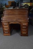 Early 20th century oak roll top desk with fitted interior supported on two pedestals, the base