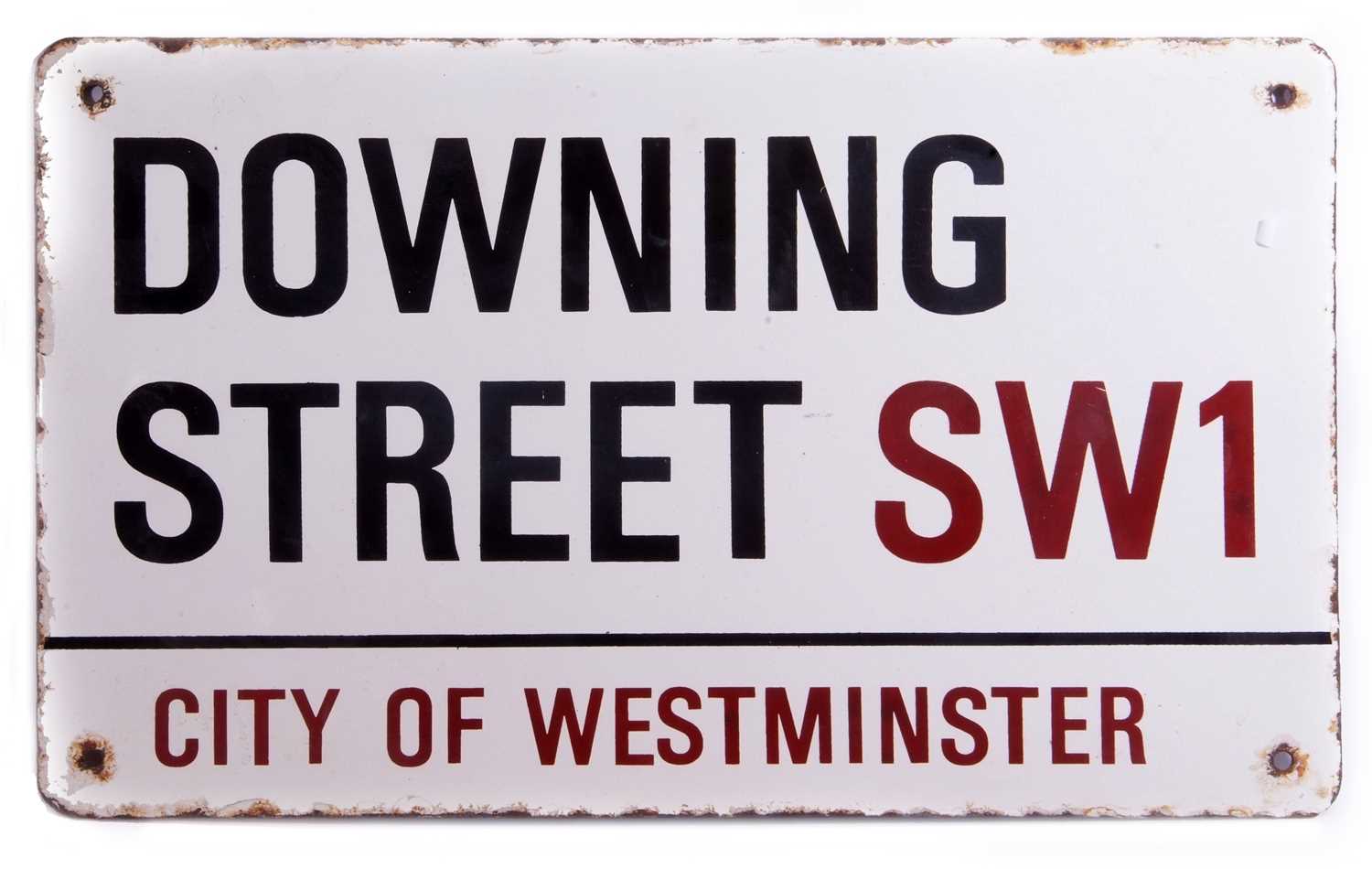 City of Westminster Downing Street sign in black and red lettering on white enamel background