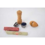 Small plastic bag containing wooden egg shaped thimble holder with view of Battle Abbey, silver