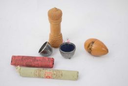 Small plastic bag containing wooden egg shaped thimble holder with view of Battle Abbey, silver