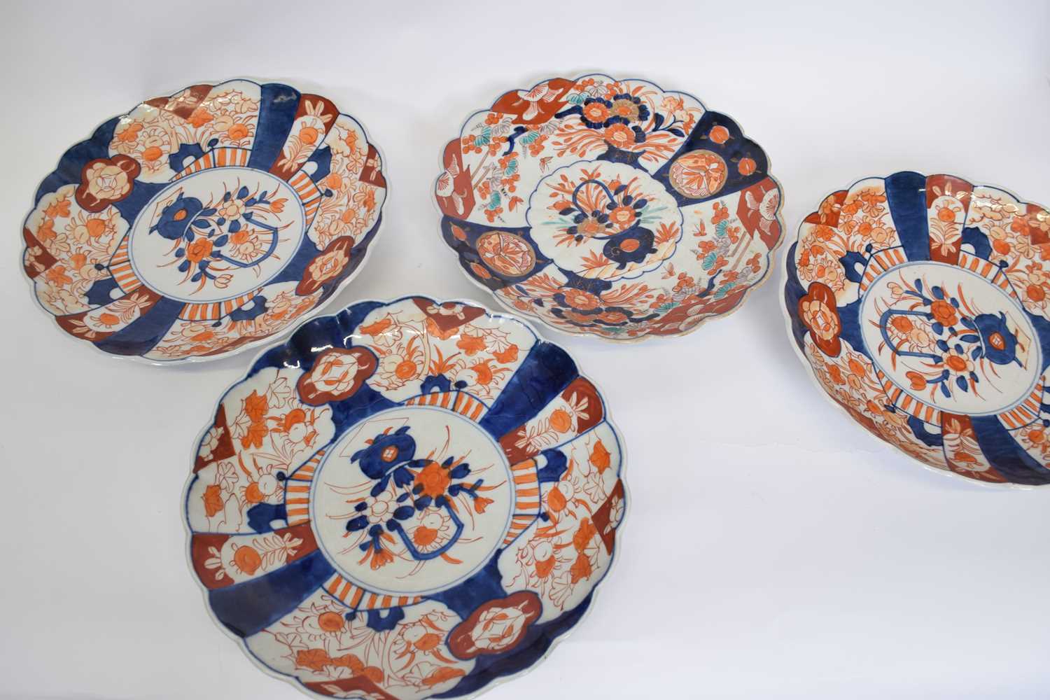 Four Japanese porcelain Imari style dishes with scalloped rims, 30cm diam (4)