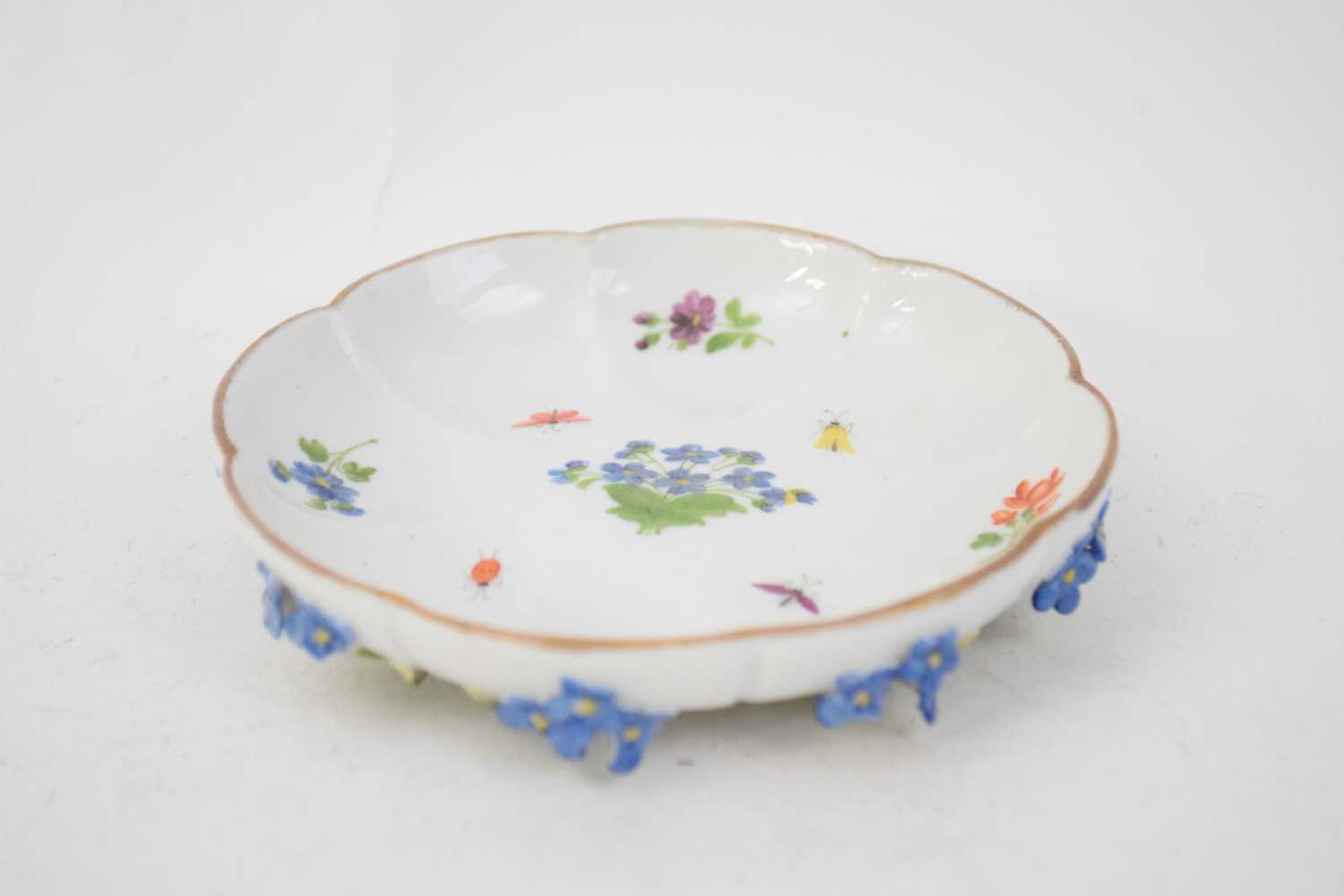 Meissen style lobed saucer decorated with flowers and insects, the base modelled with leaves and