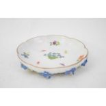 Meissen style lobed saucer decorated with flowers and insects, the base modelled with leaves and