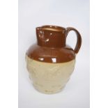 Large hunting jug with sprigged decoration with two-tone buff and brown slip, 33cm high