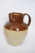 Large hunting jug with sprigged decoration with two-tone buff and brown slip, 33cm high