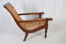 Far Eastern hardwood tea planters chair with caned back and seat, raised on turned front legs,