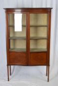 Edwardian mahogany serpentine front china display cabinet with two glazed doors, fabric lined