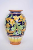 Italian Majolica vase decorated in typical colours, 33cm high