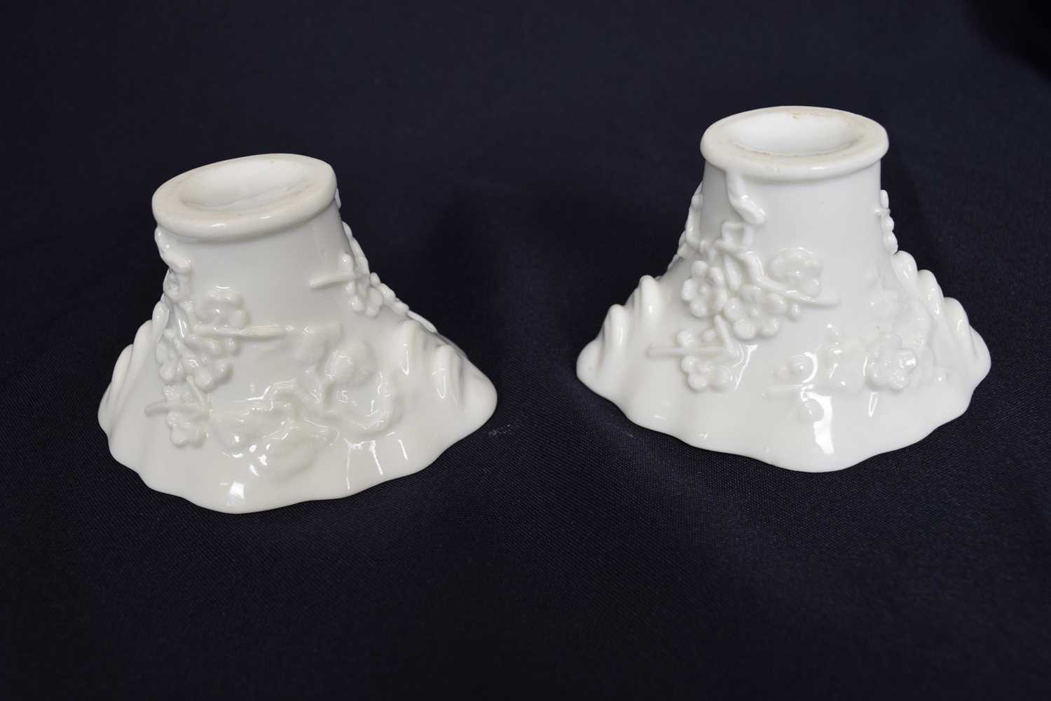 Pair of Chinese porcelain libation cups with moulded prunus design (2)