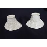 Pair of Chinese porcelain libation cups with moulded prunus design (2)