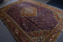 20th century fine Bijar wool floor rug decorated with large central blue panel surrounded by a