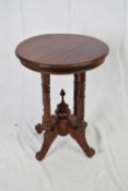 Small Far Eastern hardwood table in the Victorian style, circular top supported on four turned legs,