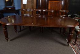 Victorian mahogany extending dining table of oval form, set on tapering fluted legs with brass and