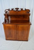 Victorian mahogany chiffonier with carved floral pediment over a small shelf supported with S-shaped