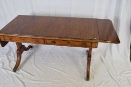 19th century mahogany drop leaf sofa table raised on end supports with four swept legs and brass end