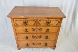 Late 19th/early 20th century oak chest of drawers in the Arts & Crafts style, the serpentine top