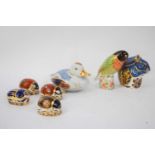 Quantity of Royal Crown Derby paperweights, one black faced love bird signed by Sue Rowe, also a