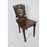 Victorian oak Gothic carved hall chair with pierced shield decorated back, raised on bobbin turned