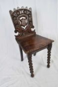 Victorian oak Gothic carved hall chair with pierced shield decorated back, raised on bobbin turned