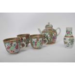 Group of Cantonese famille rose wares including small tea pot, three cups and small vase, all with