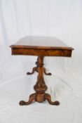 Victorian burr walnut veneered centre table, the shaped rectangular top raised on tapering columns