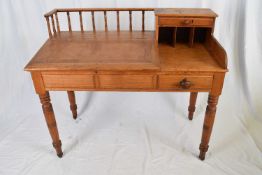 Victorian pitch pine desk with sloped hinged writing surface opening to a storage recess with