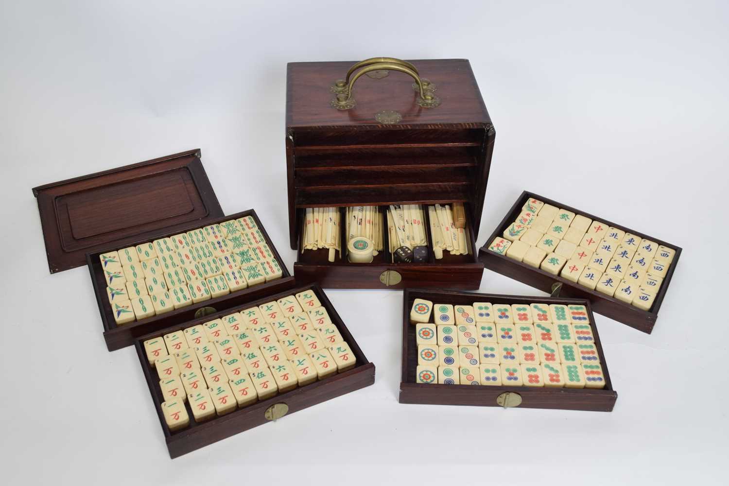 Chinese Mah Jong set in a hardwood case with metal mounts, the lift off front revealing five drawers