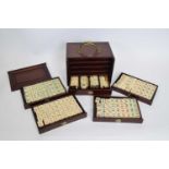 Chinese Mah Jong set in a hardwood case with metal mounts, the lift off front revealing five drawers